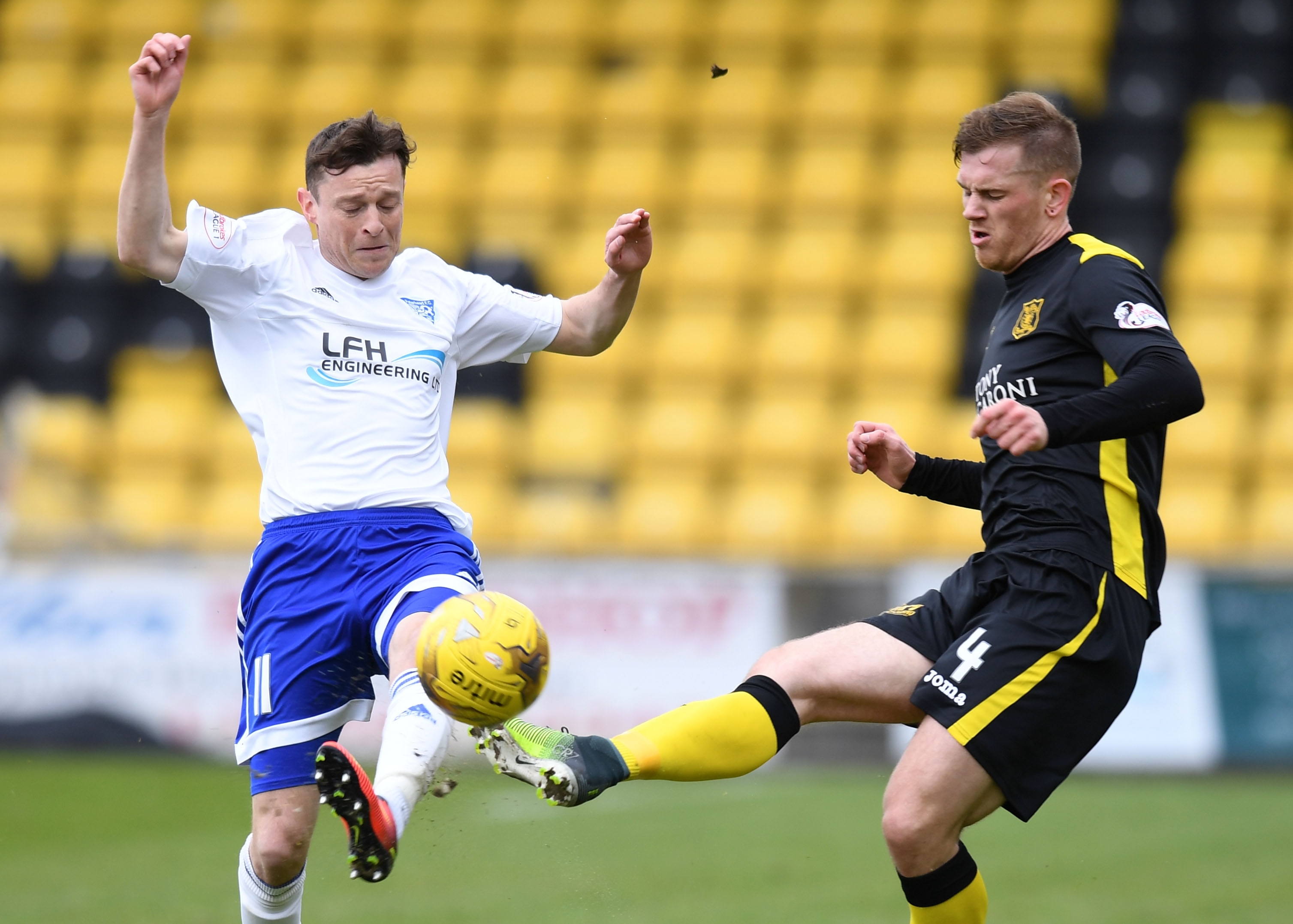 Livingston's Alan Lithgow (right) competes with Peterhead's Nicky Riley