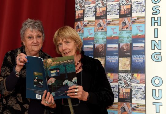 In the picture are from left: Dolleen Maclennan, left and Hilda Frewin with the front cover.