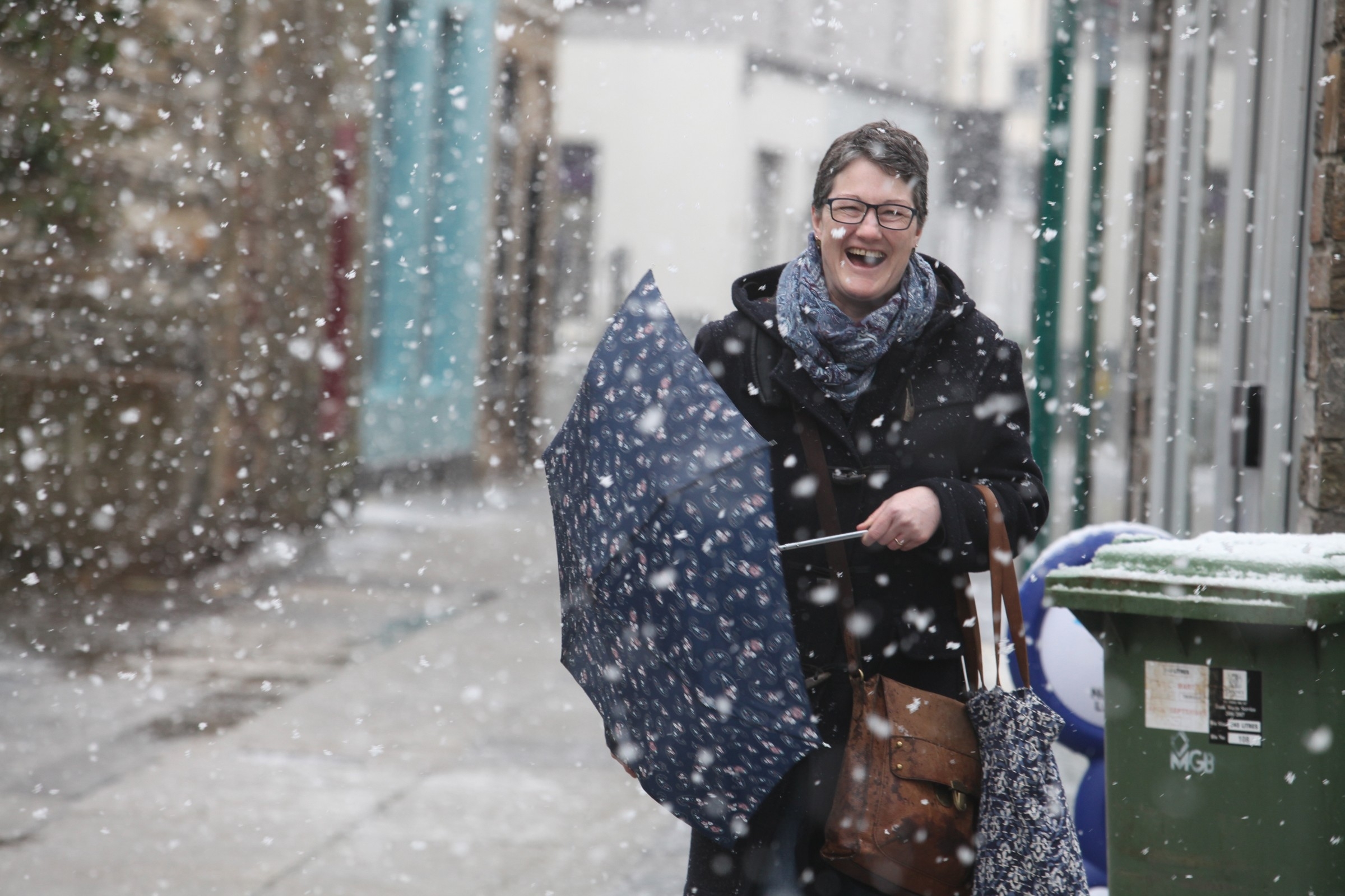 A Kirkwall shopper enjoying the spring snow this morning.