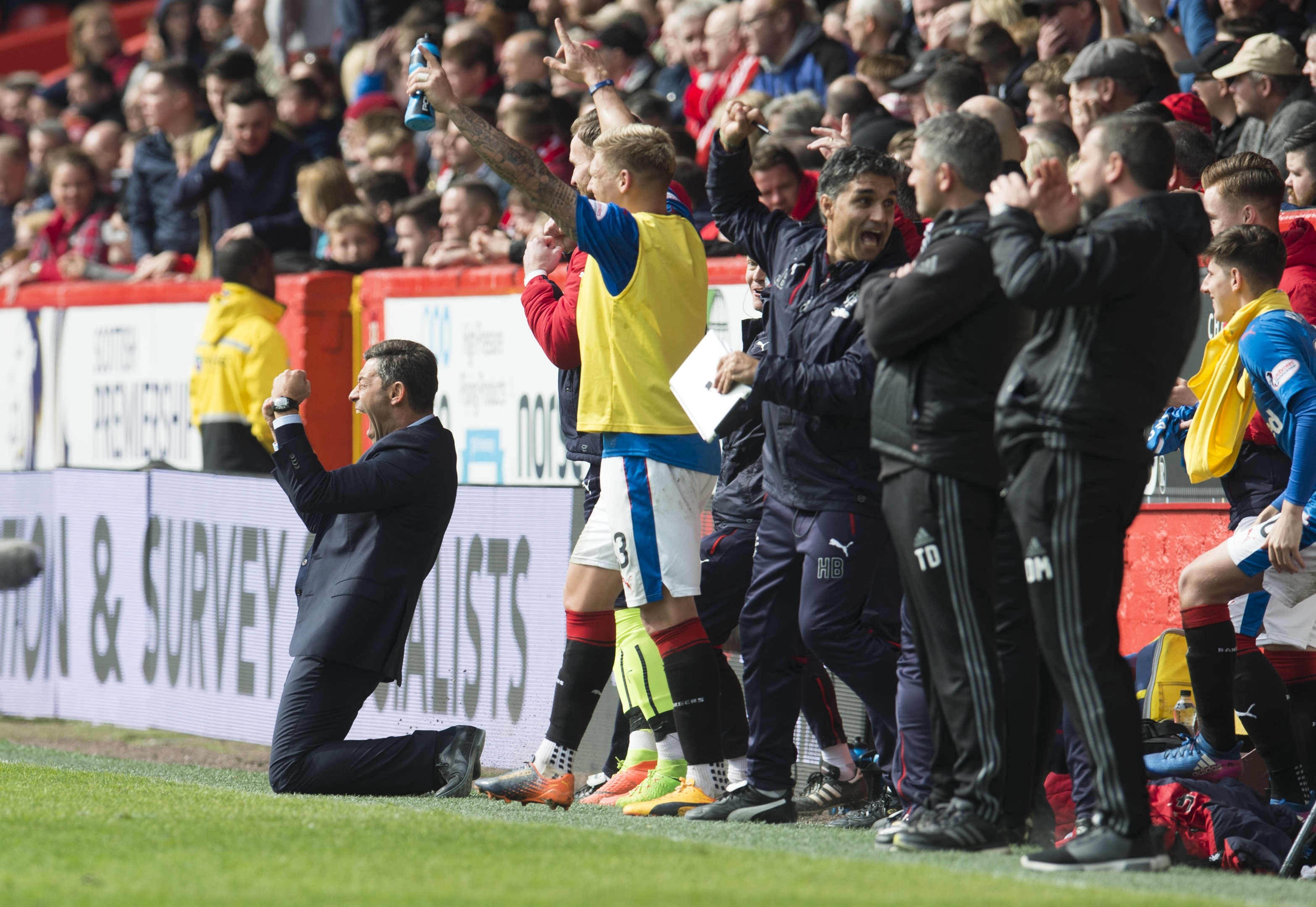 The Rangers bench celebrates as the Dons coaches look on, stunned