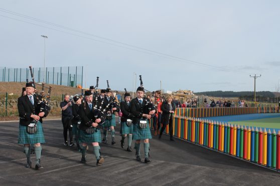 The Newtonhill pipers lead the way into the newly opened Hillside Primary School.