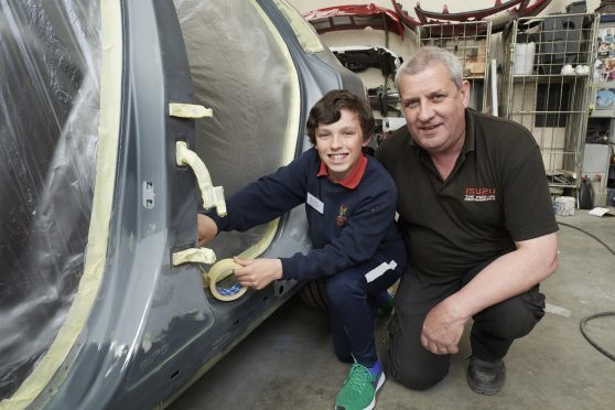Rhuairidh MacDonald with his dad Philip MacDonald at the Donald Mackenzie car body shop.
