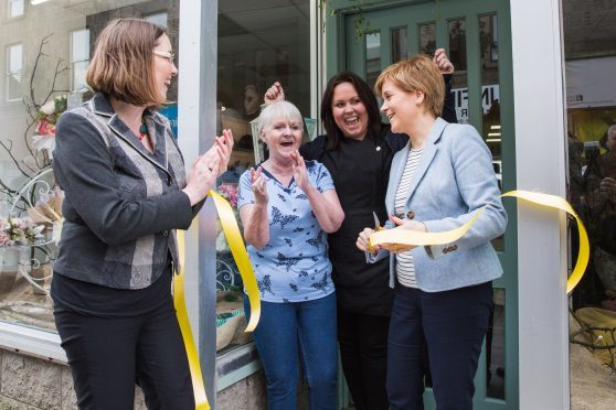 Eilidh Whiteford and Nicola Sturgeon help mother and daughter pair Kathleen Schuitema and Lindsay Palmer open their shop.