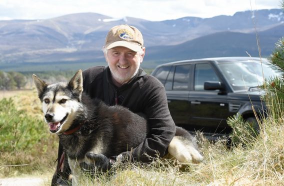 Alan Stewart of Rothiemnurchus with one of his Alaskan Huskies. Pic by Sandy McCook
