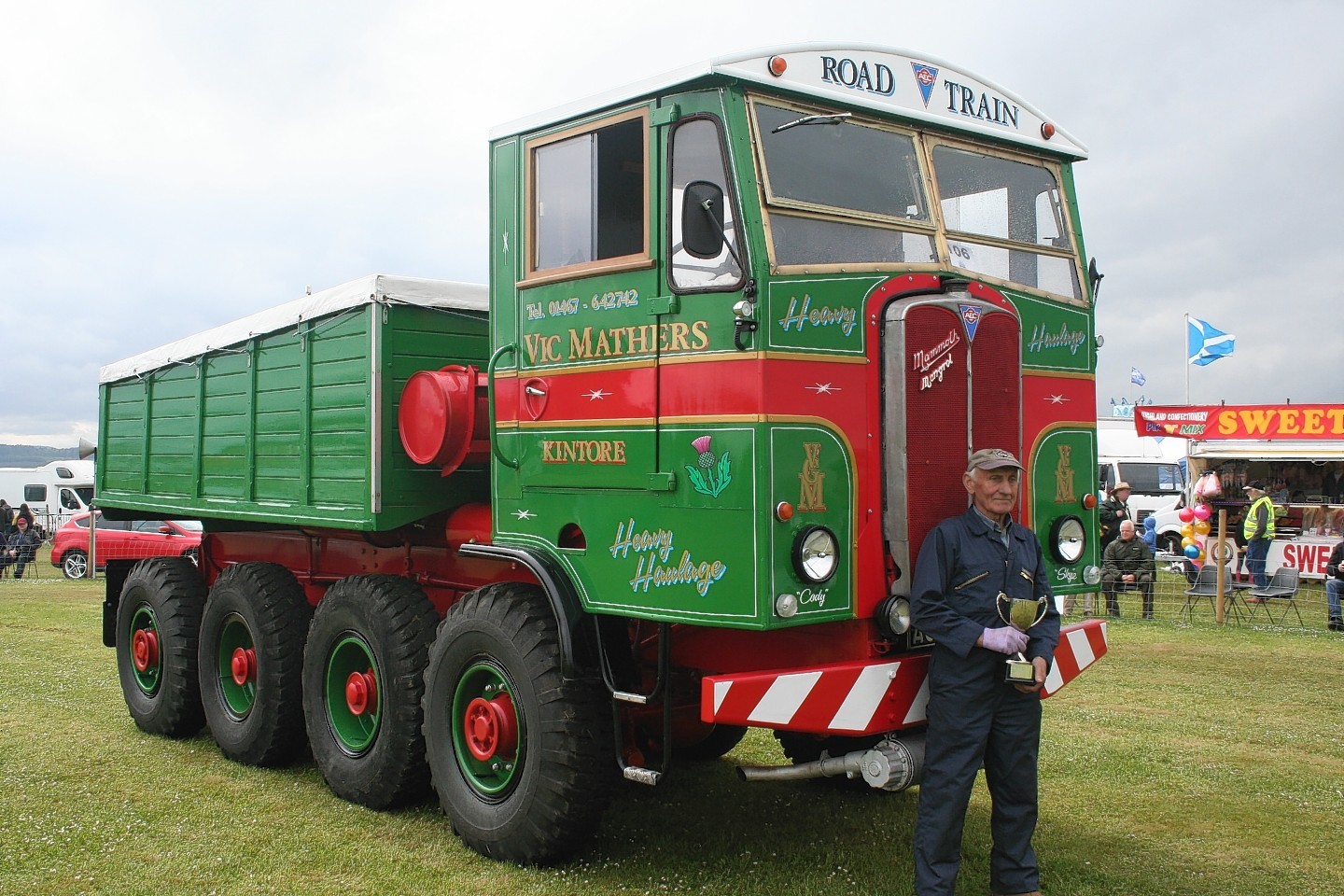 Vic Mathers of Kintore with his award in front of his masterful eight-wheel drive AEC Road train creation.