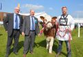 Simmental Society chief executive Neil Shand, Moray breeder Iain Green and Christopher Weatherup with the champio in 2017.