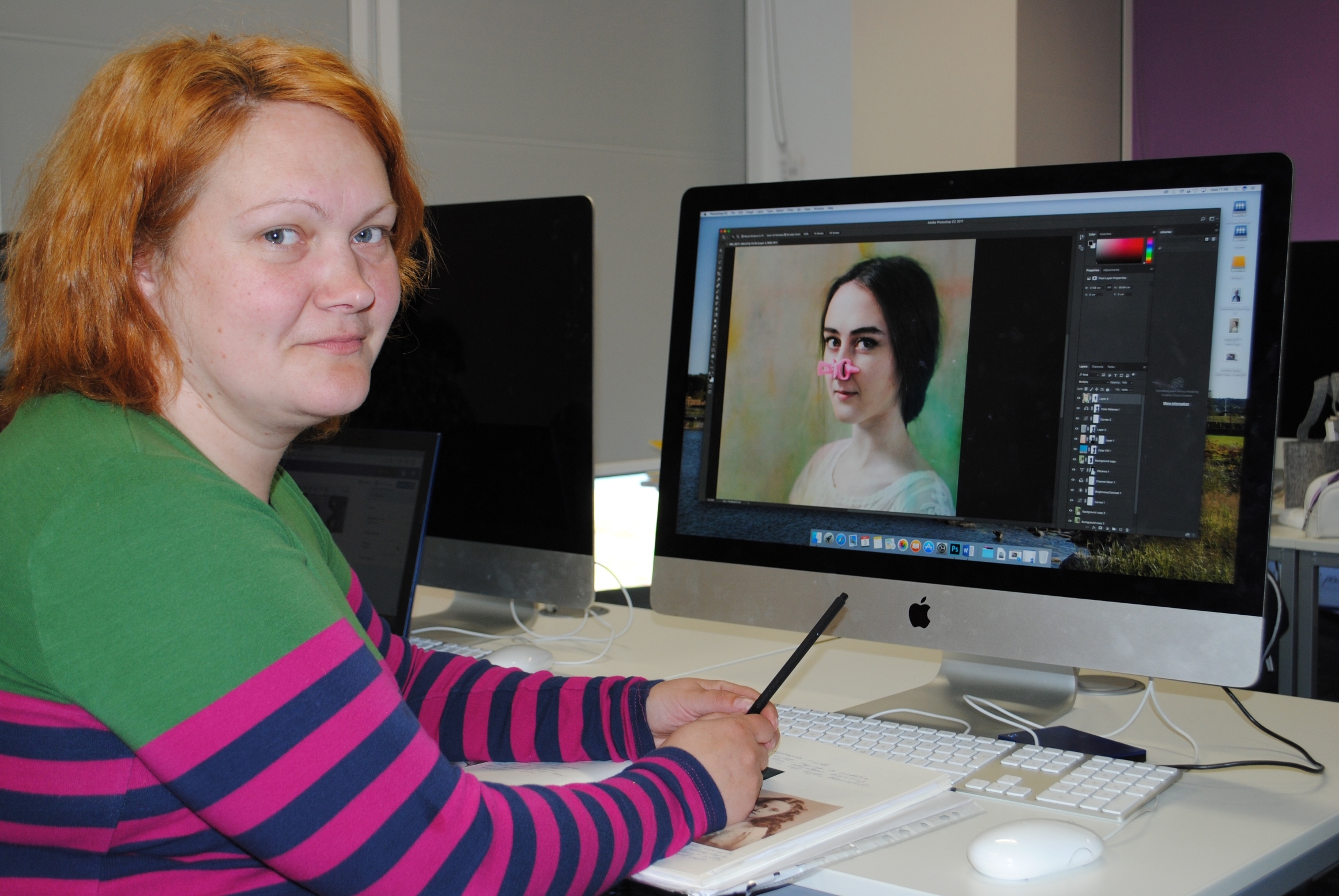 Evija Laivina at Inverness College UHI with an image from her award-winning 'Beauty Warriors' series