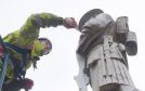 Face to face with the marble soldier, Calum Ross cleans off years of grime from the Fort William war memorial.