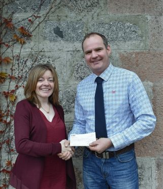 Nina Clancy receives a cheque from Dave Gill