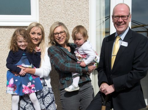 (L-R): Osprey Heights tenant Susannah Henderson with daughters Amelia and Harper, Gillian Martin MSP and Kevin Stewart MSP