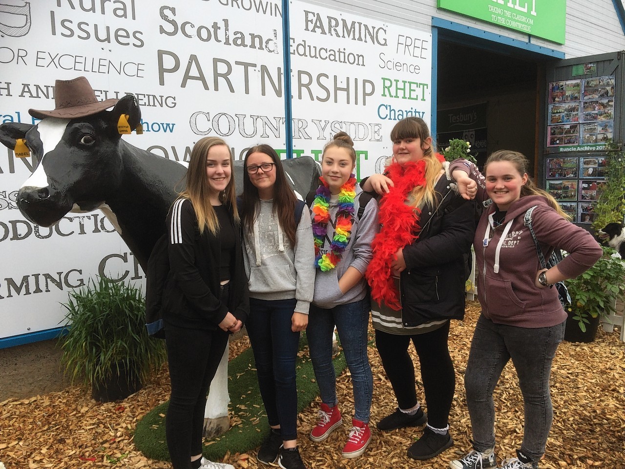 Secondary students outside the RHET Discovery Centre next to Mabel, one of RHET’s fibreglass milkable cows.