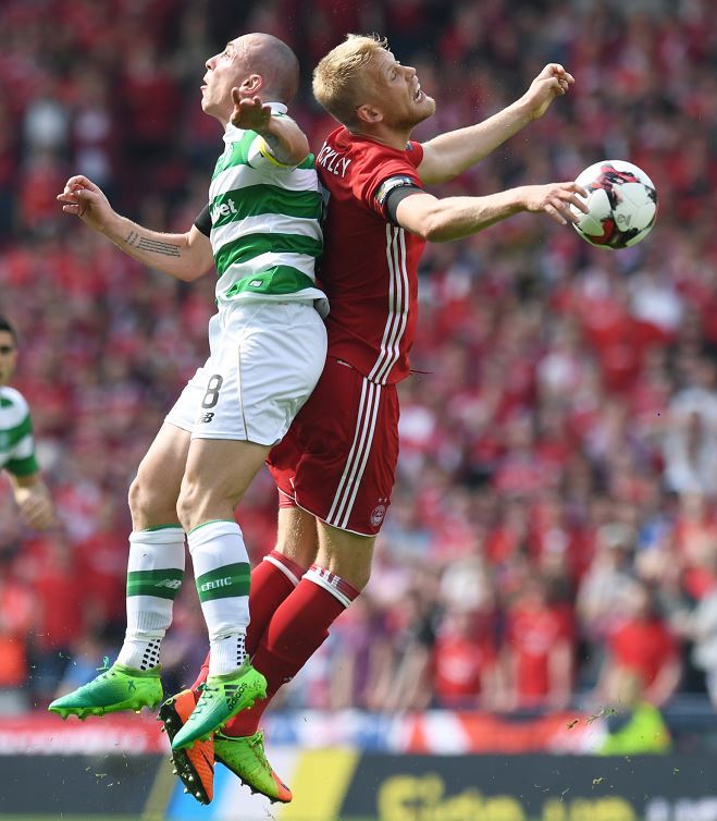 Celtic's Scott Brown (left) and Aberdeen's Jayden Stockley compete for the ball