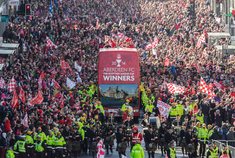 Sunday March 23rd 2014, Aberdeen, Scotland. Thousands of Dons supporters watch an open-top bus carrying the team from Albyn Place, down along Union Street to the Town House.