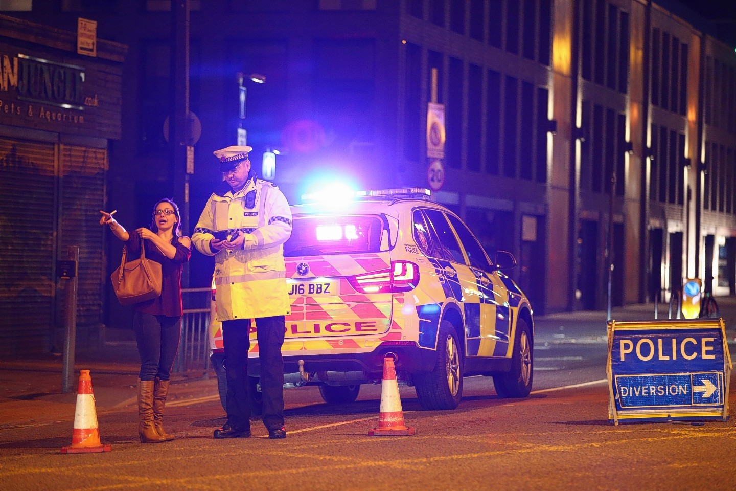 Police stand by a cordoned off street close to the Manchester Arena