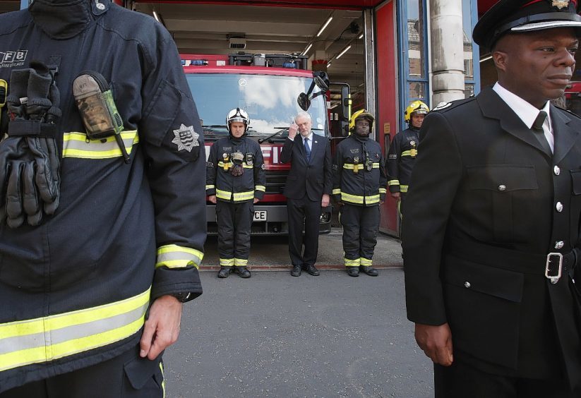 Labour leader Jeremy Corbyn (third right back) joins fire fighters at Islington Fire Station, north London, as he observes a minute's silence to remember the victims of the Manchester terror attack