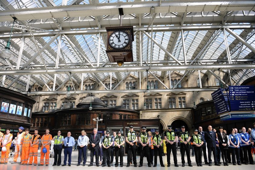 Travellers and staff hold a minute's silence at Glasgow Central Station