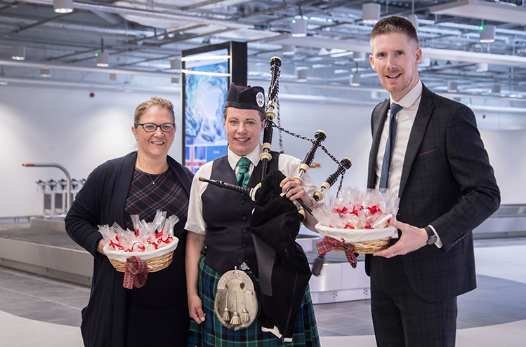 Aberdeen Airport’s Carol Benzie, Managing Director; Karen Bain, traditional piper and Terminal Safety Officer; and John Deffenbaugh, Head of Capital