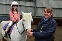 Aberdeen Riding Club manager Sally McCarthy with nine-year-old Abigail Gray.