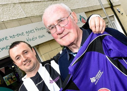 John MacLennan (right) with his Alzheimer Scotland Football shirt which was presented by Kenny Wright (left)