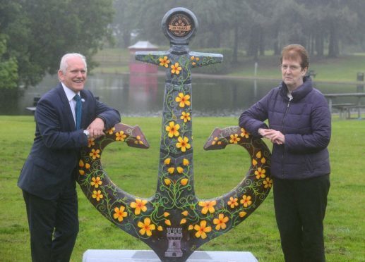 Robertson's managing director Frank Reid and Moray Council's principal librarian, Sheila Campbell, in Elgin's Cooper Park.