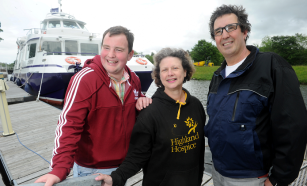 Loch Ness 'swimmers' James O'Donnell (left) of Cantraybridge College and his Maintenance Enabler Jon Lane (right) with Katie Gibb , Community Fund Raiser with Highland Hospice before their sail on Loch Ness yesterday afternoon