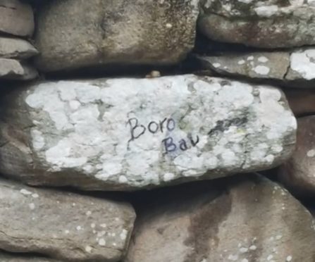 Stones have been dislodged and graffiti has been written on a rock at Clava Cairns near Culloden.