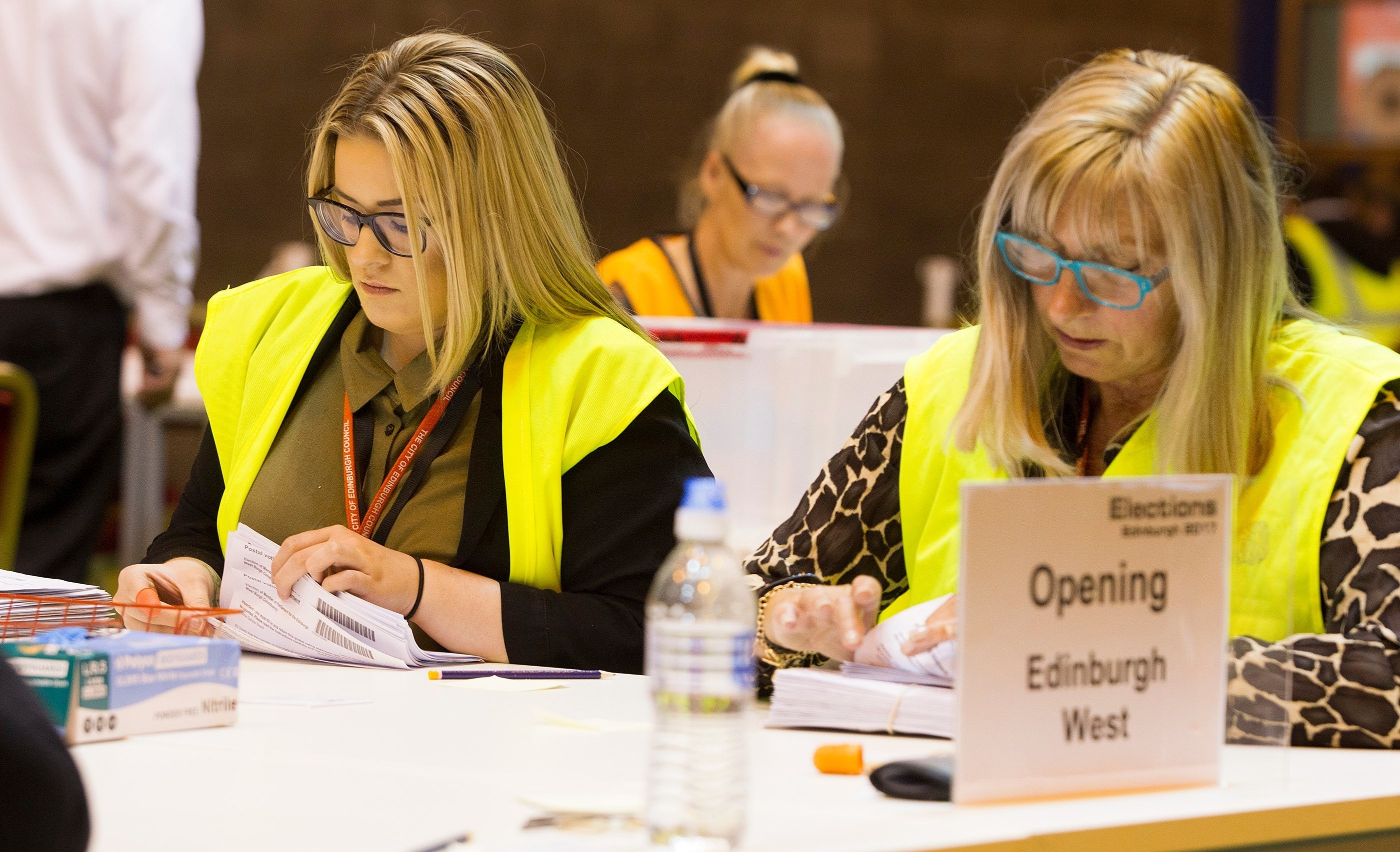 Count staff at Meadowbank Stadium, Edinburgh, sort postal votes for the General Election.