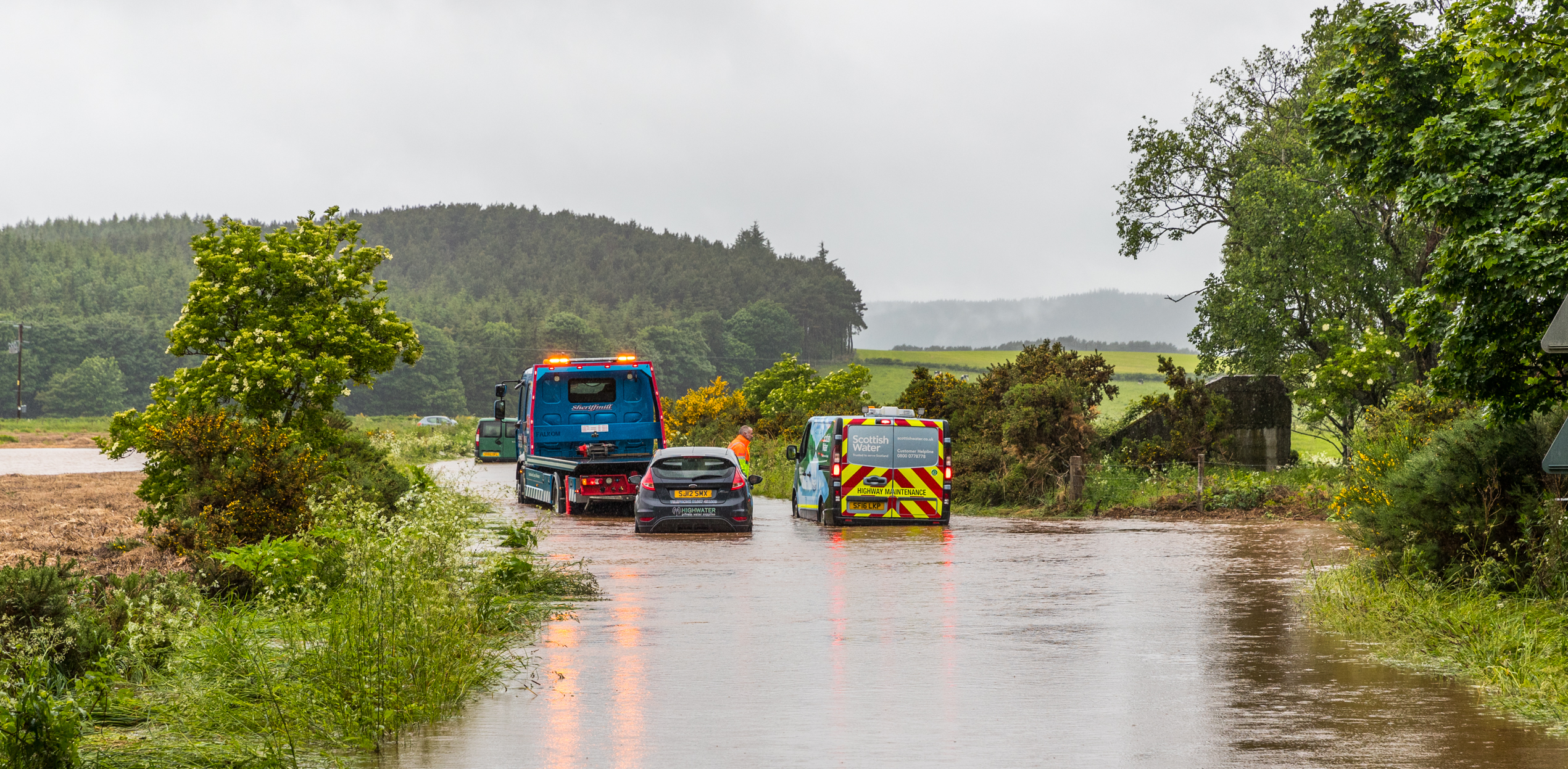 This is the unclassified road near Cloddach just outside Elgin, car has broken down in the flood.