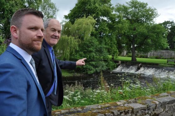 Moray Council leader George Alexander, pictured right, with Gordon Brailsford, owner of the Mosset Tavern, by the side of the Mosset Burn