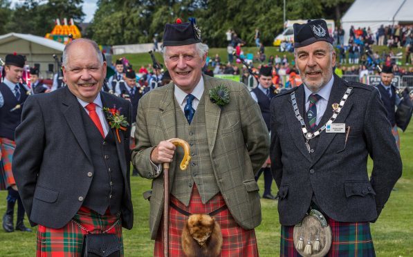 Chairman of Forres Evenets, Alan James, Chieftain, Major General Seymour Monro and George Ussher, President of the Royal Scottish Pipe Band Association