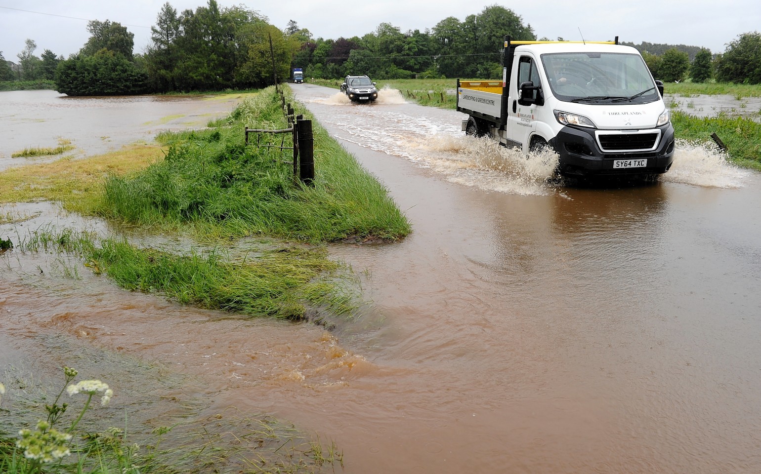 Flooded roads and railway tracks in Pliuscarden area of Elgin. Picture by Sandy McCook