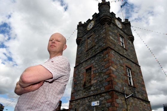 Dufftown business owner Alistair Jeffs is concerned the power lines will be taller than the Dufftown clock tower.