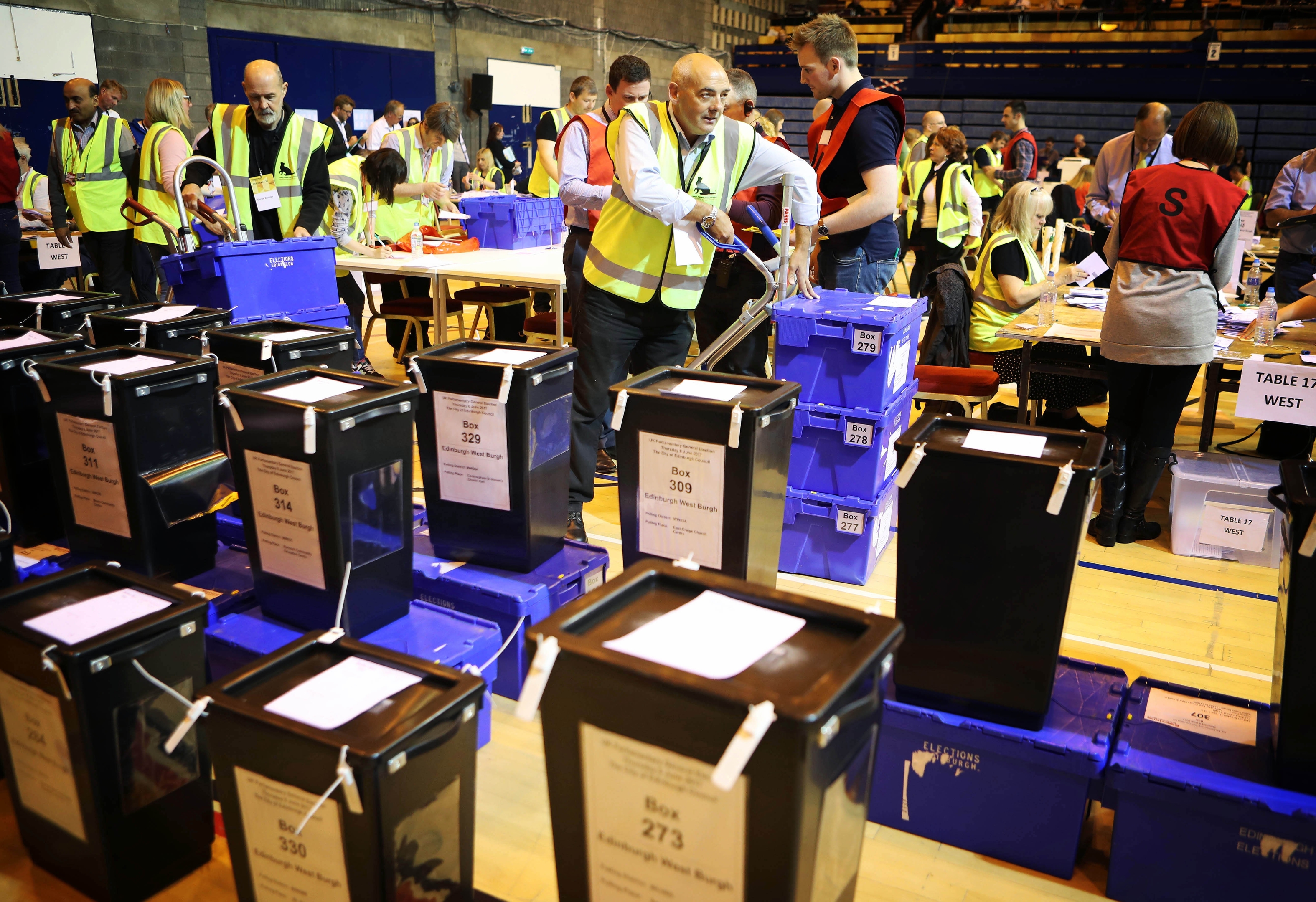 Election staff prepare to count ballot papers for the General Election