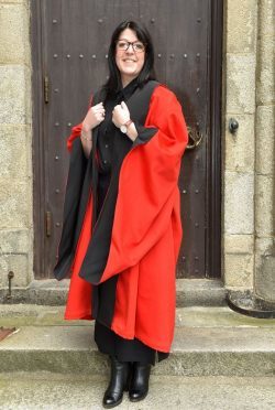 Kerry Karam, who graduated with a PhD in English Language and Linguistics outside Elphinstone Hall.