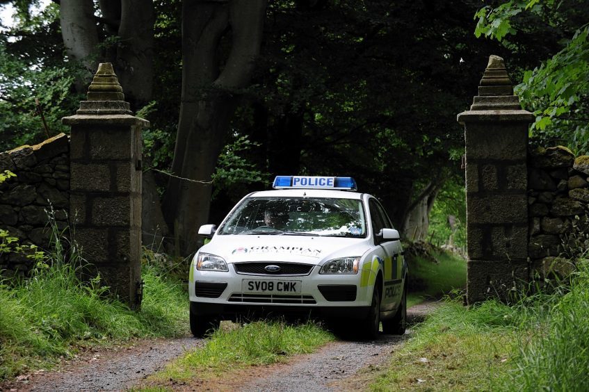 Police at the entrance to Sandy Ingram's home in 2010