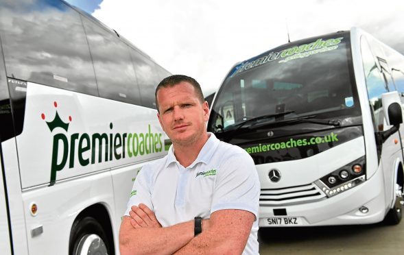 BUSINESS ;  Premier Coaches have invested £1million on six new vehicles over the past six months.      Pictured - Managing Director Alan Findlater with two of his new coaches.       Picture by Kami Thomson    31-07-17