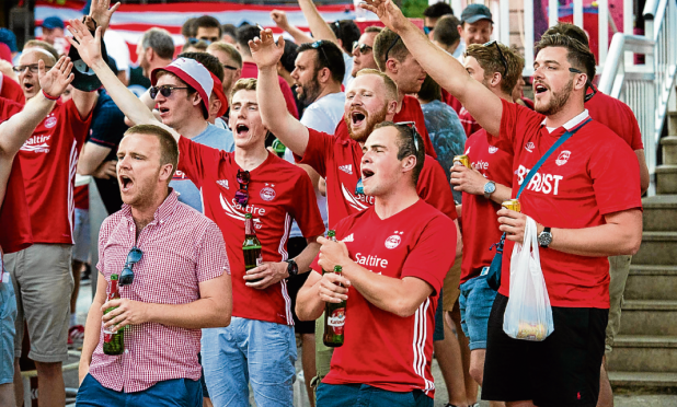 Dons fans enjoy a musical interlude on their way to the stadium for yesterday’s match against Siroki Brijag in Bosnia