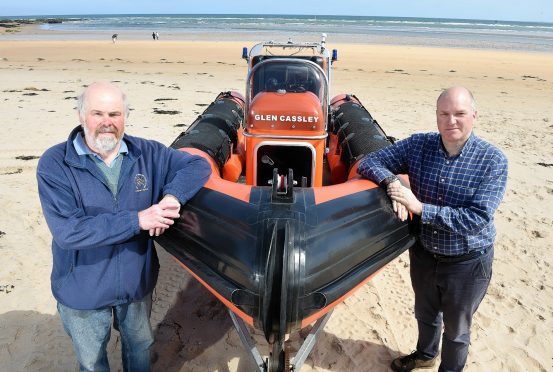 Photographed with their lifeboat on Dornoch Beach are Neil Dalton (left) Chairman of the Association and on the right Antony Hope, a crew member.