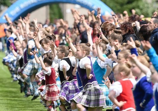 Picture by SANDY McCOOK    19TH jULY '15
Inverness Highland Games, Bught Park. Young Highland Dancers perform a massed Highland Fling as part of the opening ceremony.