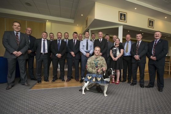 Description: Sgt Dee the dog is introduced to the WOs and SNCOs Mess at RAF Lossiemouth on promotion. Dee is the Station mascot
Originator: FS Young
Section: Police
Ext: 
*For more information contact Photographic Section, RAF Lossiemouth, IV31 6SD. Tel: 01343 817191