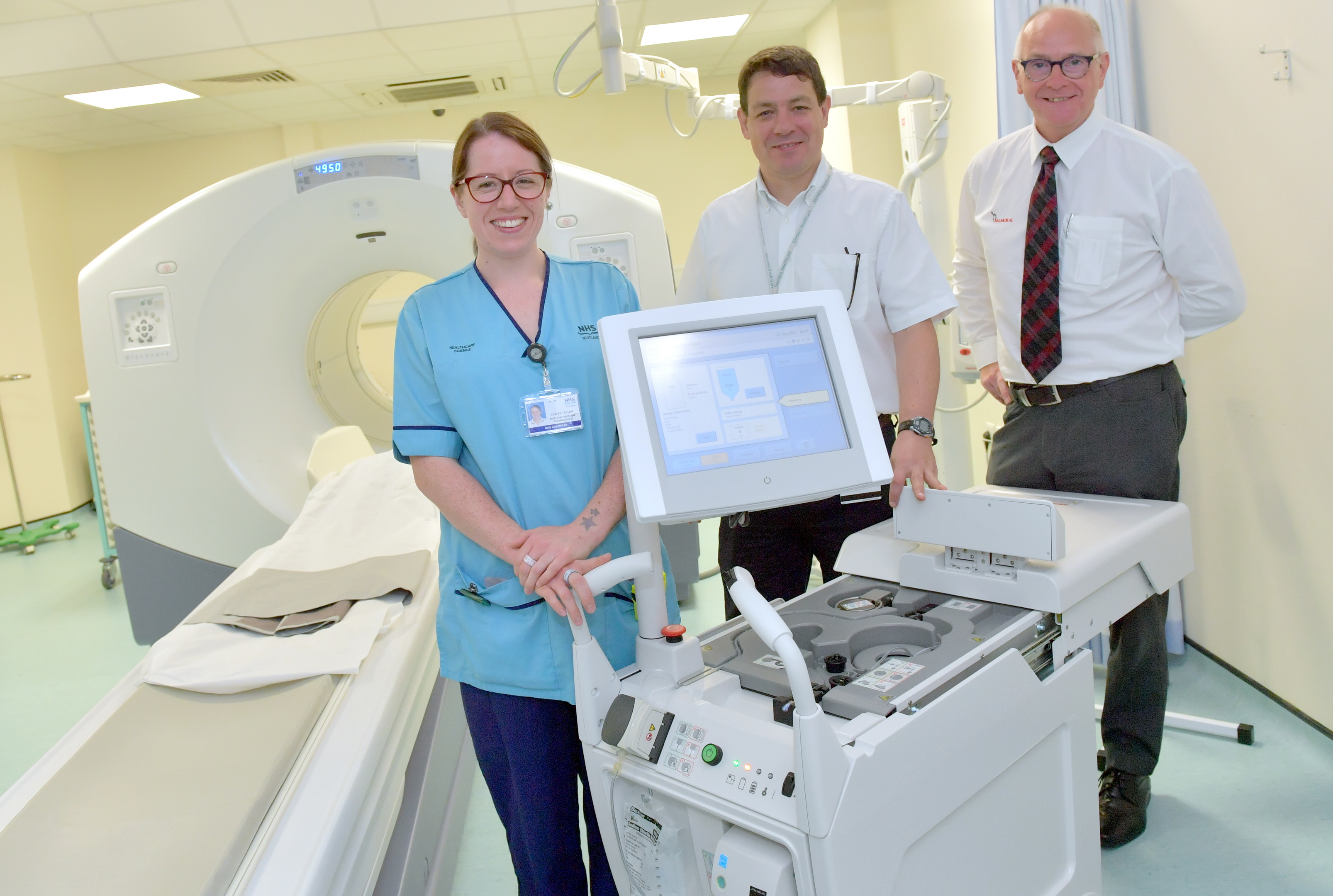 Pictured - L-R Nuclear Medicine Technologist Claire Taylor, Dr Roger Staff and Steve Gibb of Friends of Anchor with the new machine.   
Picture by Kami Thomson