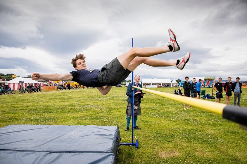 A competitor clears the bar in the high jump at the Tain Highland Gathering.