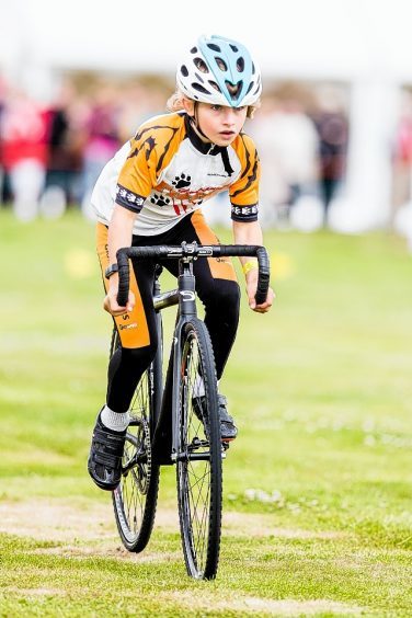 A junior cyclcist takes part in the time trial at the Tain Highland Gathering.