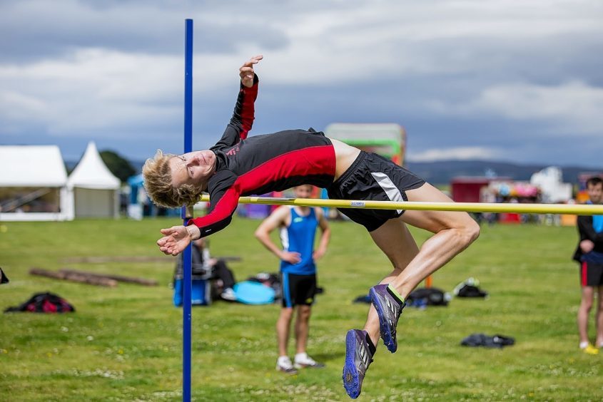 Flying high; A competitor clears the bar in the high jump at the Tain Highland Gathering.