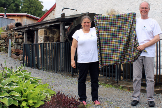 John and Christine Carney, of the charity Busega Scotland, with the special Knockando shuka