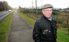 Picture by SANDY McCOOK    28th December '16
Smithton and Culloden Community Council Chairman at the site of the proposed housing development on Tower Road where they have concerns over access.