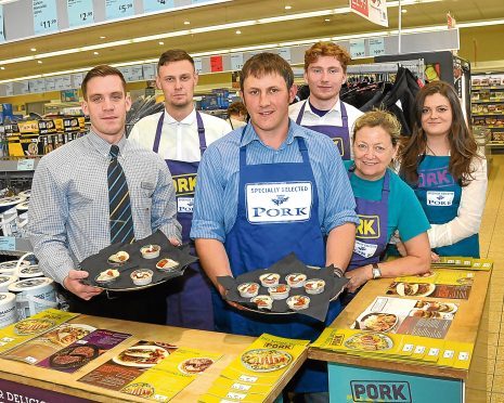 Russell Rennie, centre, in Aldi’s Inverurie store with manager Jamie Lucas and the Specially Selected Pork ambassadors.