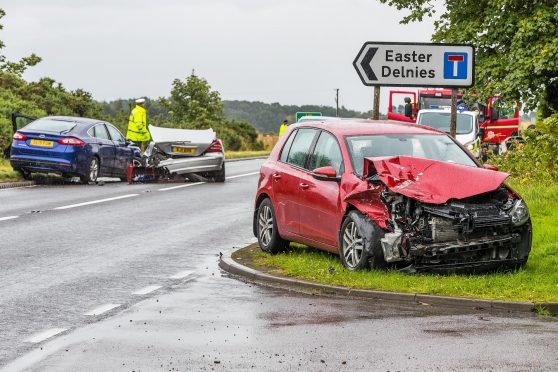 This is the scene of the RTC on the A96 at Easter Delnies junction. It involves a Blue Ford Mondeo, Silver Mercedes Sports and Burgundy VW Golf. 3 Units of Fire Brigade were in attendance and packing up following havinf cut a person from the Mercedes. The Helicopter Ambulance was also in attendance.