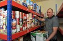 Gilbert Grieve helps put food handouts together for Moray Foodbank.