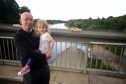 Cllr Marc MacRae at the Old Bridge over the Spey, next to the A96 at Fochabers with his 3 year old granddaughter, Emelia Stanforth.

Photo by
Michael Traill						
9 South Road
Rhynie
Huntly
AB54 4GA

Contact numbers
Mob	07739 38 4792
Home	01464 861425